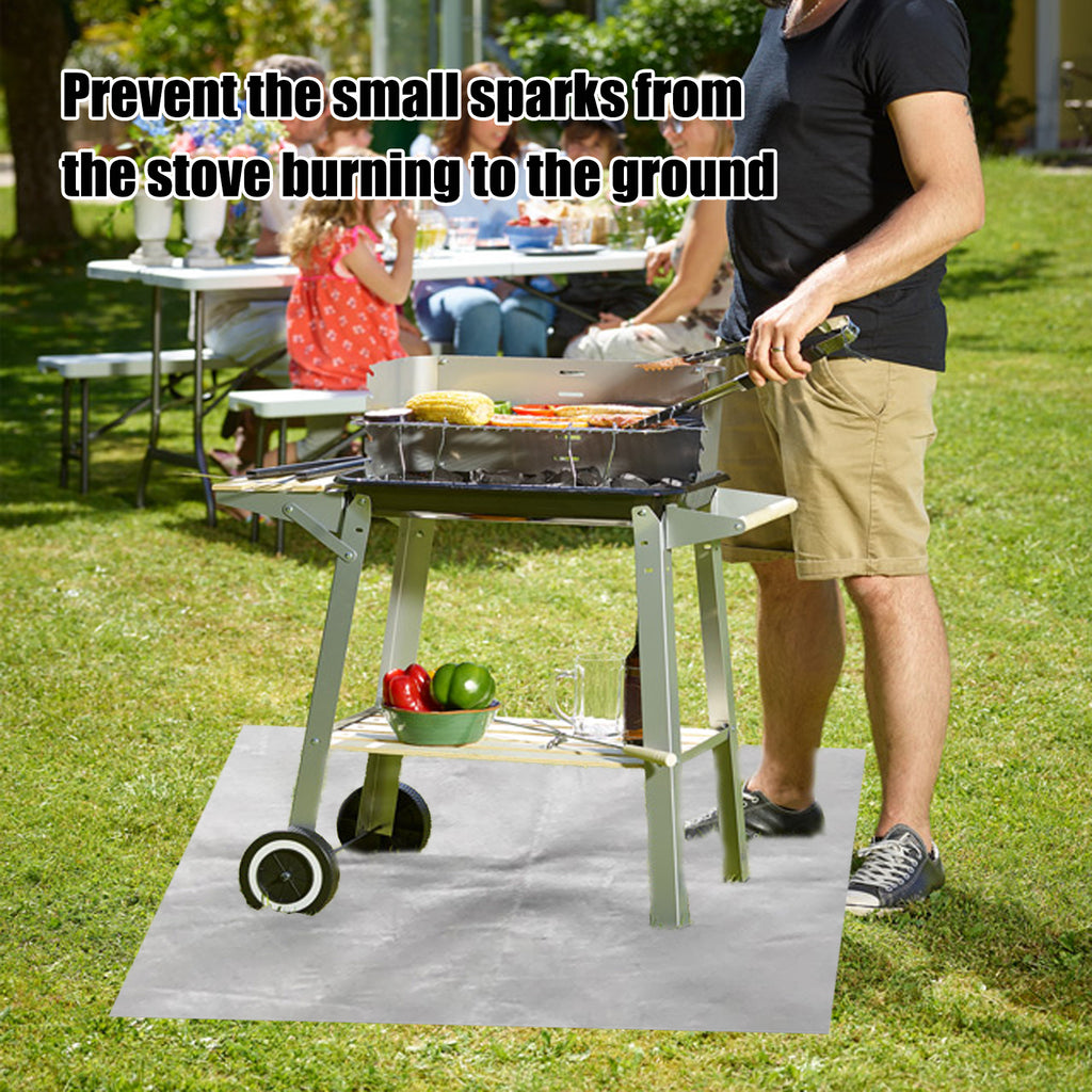 Silver protective mat positioned under an outdoor grill